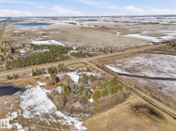 Aerial perspective showcasing a parcel of land with a treed area - 