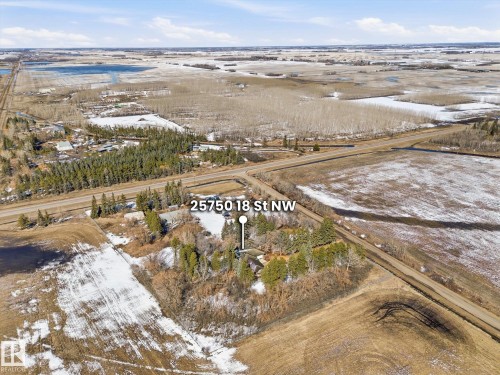 Expansive property featuring mature trees, surrounding agricultural fields, and direct road access - 25750 18 Street, Edmonton, AB - Outdoor With View