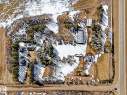 Aerial perspective showcasing a property with multiple structures - 