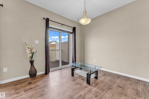 Bright interior space featuring wood-finish flooring, neutral-toned walls, and white baseboards - 2526 19A Avenue, Edmonton, AB - Indoor Photo Showing Other Room