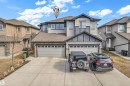 Modern two-story residence featuring a two-car garage, stone accents, and a concrete driveway - 2526 19A Avenue, Edmonton, AB  - Outdoor With Facade 