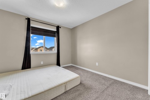Interior room featuring neutral wall paint, white trim, and carpeting - 2526 19A Avenue, Edmonton, AB - Indoor Photo Showing Bedroom
