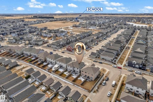 Aerial view of a residential neighborhood with detached homes, including a beige exterior home with a two-car garage - 2526 19A Avenue, Edmonton, AB - Outdoor With View