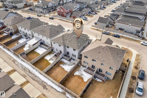 Rear exterior of a two-story residence featuring a private fenced yard and an elevated deck - 2526 19A Avenue, Edmonton, AB -  With View