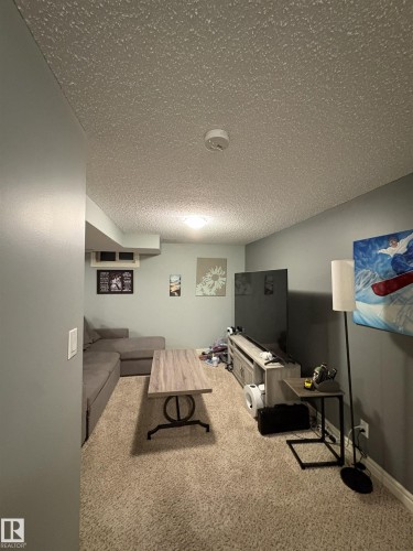 Carpeted room featuring light gray walls and a popcorn ceiling - 79 Akinsdale Gardens, St. Albert, AB - Indoor