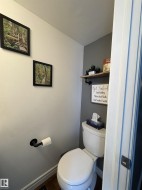 White toilet with a white tank and round bowl - 