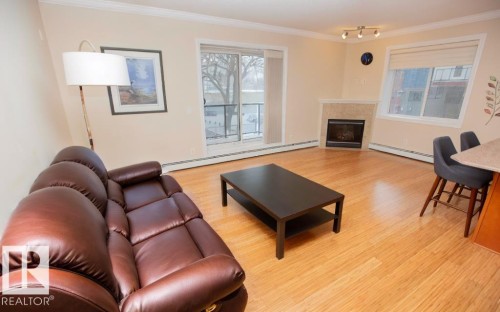 202 8631 108 Street, Edmonton, AB - Indoor Photo Showing Living Room With Fireplace