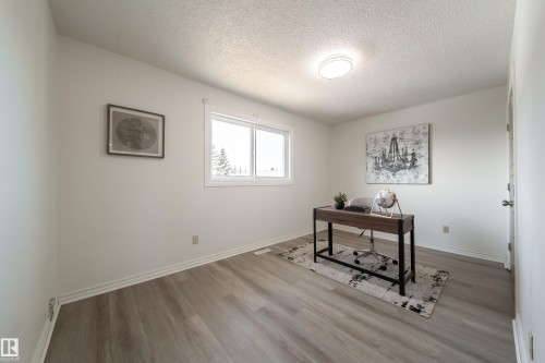 This room features light-colored flooring, a window providing natural light, and a ceiling light fixture - 3518 78 Street, Edmonton, AB - Indoor