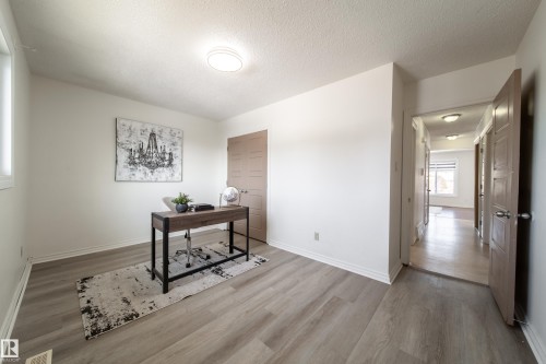 The property features light-colored walls, light wood-style flooring, and a window providing natural light - 3518 78 Street, Edmonton, AB - Indoor