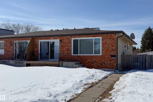 The property features a brick exterior with a pitched roof, multiple windows, and a paved walkway leading to the entrance - 3518 78 Street, Edmonton, AB - Outdoor