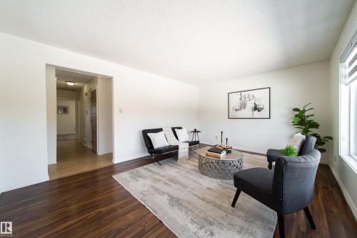 Living area featuring dark wood flooring and light-colored walls - 3518 78 Street, Edmonton, AB - Indoor