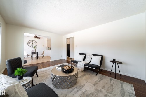 The living room features hardwood flooring and light-colored walls, creating a bright atmosphere - 3518 78 Street, Edmonton, AB - Indoor Photo Showing Living Room