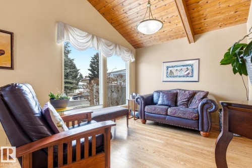 Vaulted wood-paneled ceiling, expansive picture window, and wood-finish flooring - 11707 29 Avenue Nw, Edmonton, AB - Indoor Photo Showing Living Room