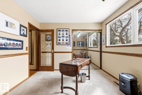 Cream-colored walls with wood trim and chair rail detailing - 11707 29 Avenue Nw, Edmonton, AB - Indoor Photo Showing Other Room