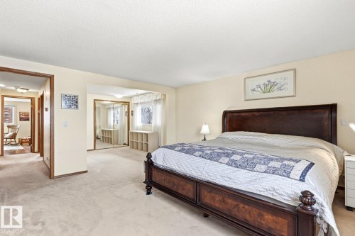 Spacious room featuring neutral carpeting and light-toned walls - 11707 29 Avenue Nw, Edmonton, AB - Indoor Photo Showing Bedroom