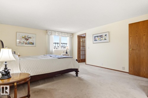 Carpeted room featuring light-toned walls and a window with a valance - 11707 29 Avenue Nw, Edmonton, AB - Indoor Photo Showing Bedroom