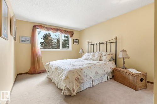 Carpeted room featuring light-toned walls and a white-framed window - 11707 29 Avenue Nw, Edmonton, AB - Indoor Photo Showing Bedroom