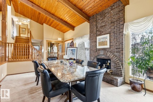Vaulted wood-plank ceiling with exposed beams - 11707 29 Avenue Nw, Edmonton, AB - Indoor Photo Showing Dining Room With Fireplace
