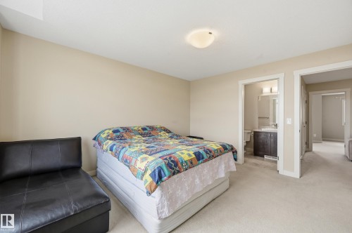 Bedroom with neutral colored walls and light-toned carpet - 701 Allard Boulevard, Edmonton, AB - Indoor Photo Showing Bedroom