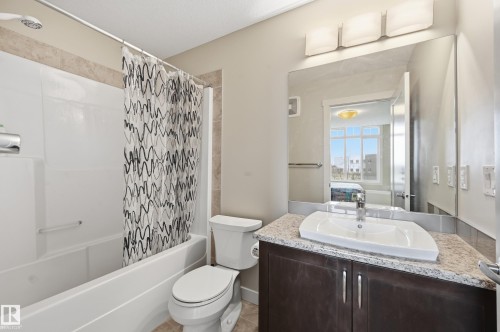 Bathroom with a shower and bathtub combination, a vanity with a granite countertop, and a large mirror - 701 Allard Boulevard, Edmonton, AB - Indoor Photo Showing Bathroom