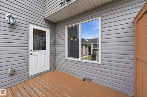 Outdoor deck space with direct access to the interior, featuring durable siding and a window providing natural light - 701 Allard Boulevard, Edmonton, AB - Outdoor With Exterior