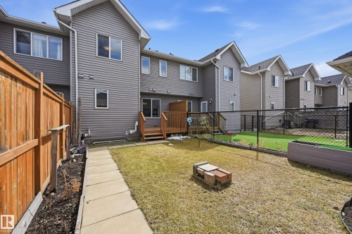 The property features a private backyard with a lawn and concrete pathway - 701 Allard Boulevard, Edmonton, AB - Outdoor With Deck Patio Veranda With Exterior