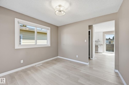 This bright room features light-colored flooring and neutral-toned walls, creating an inviting atmosphere - 6907 19 Avenue, Edmonton, AB - Indoor Photo Showing Other Room