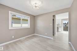 This bright room features light-colored flooring and neutral-toned walls, creating an inviting atmosphere - 