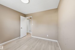This room features light-colored flooring, neutral-toned walls, and white trim - 