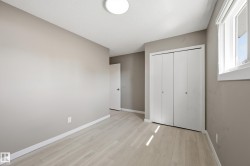 Room featuring light-colored flooring, neutral-toned walls, a window, and a closet with bi-fold doors - 