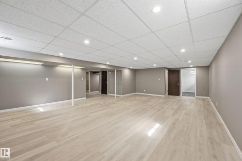 Expansive room featuring light-toned flooring, recessed lighting, and neutral-colored walls - 6907 19 Avenue, Edmonton, AB - Indoor Photo Showing Other Room