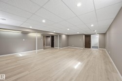 Expansive room featuring light-toned flooring, recessed lighting, and neutral-colored walls - 