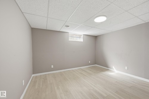 This room features light-colored flooring, neutral-toned walls, and a drop ceiling with recessed lighting - 6907 19 Avenue, Edmonton, AB - Indoor Photo Showing Other Room