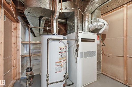 The utility room includes a water heater, furnace, and built-in shelving - 6907 19 Avenue, Edmonton, AB - Indoor Photo Showing Basement