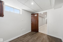 This room features a window, recessed lighting, and wood-look flooring - 