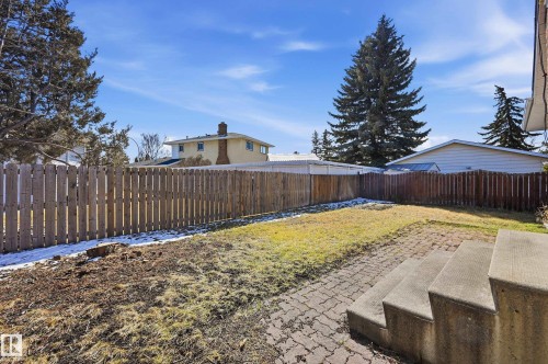 The property features a fenced yard with a combination of grass and exposed earth - 6907 19 Avenue, Edmonton, AB - Outdoor