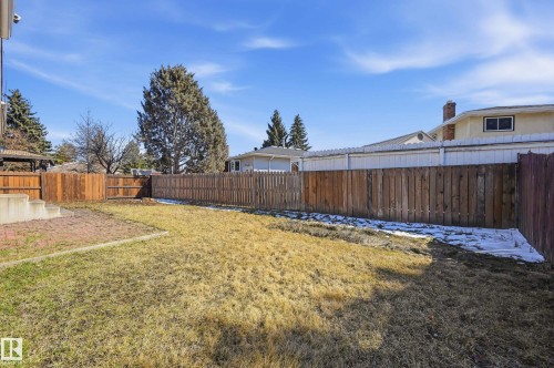 The property features a fenced yard with a lawn area and a paved patio - 6907 19 Avenue, Edmonton, AB - Outdoor