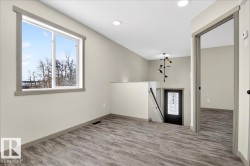 Open interior space featuring wood-finish flooring and a large window - 