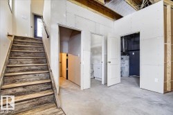 Distressed wood-finish staircase and handrail leading to an upper level - 
