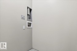 Utility area featuring a 240V outlet, dryer vent hookup, and plumbing connections - 