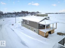 Contemporary home with two-tone siding, an elevated deck, and a covered entry - 
