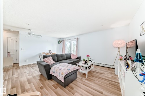 Spacious living area featuring light-toned flooring, white walls, and a ceiling fan - 317 7511 171 Street, Edmonton, AB - Indoor Photo Showing Living Room