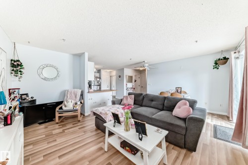 The living area features light-colored flooring, light-colored walls, and a ceiling fan - 317 7511 171 Street, Edmonton, AB - Indoor Photo Showing Living Room