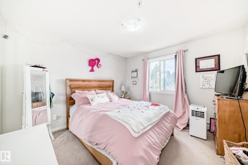 This bedroom features light-colored walls and carpeted flooring, creating a neutral backdrop - 317 7511 171 Street, Edmonton, AB - Indoor Photo Showing Bedroom