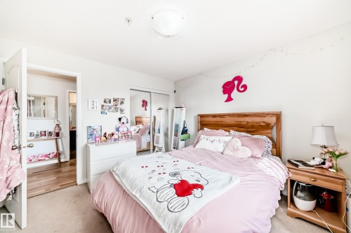 This room features light-colored walls and carpeted flooring, creating a bright atmosphere - 317 7511 171 Street, Edmonton, AB - Indoor Photo Showing Bedroom