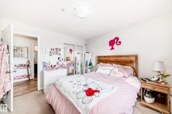 This room features light-colored walls and carpeted flooring, creating a bright atmosphere - 