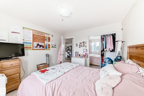 This room features light-colored walls and a ceiling light fixture - 317 7511 171 Street, Edmonton, AB - Indoor Photo Showing Bedroom