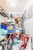 The property offers a dedicated storage area with wire shelving and a ceiling light fixture - 