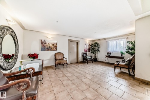 The property features a spacious room with tile flooring and bright white walls - 317 7511 171 Street, Edmonton, AB - Indoor