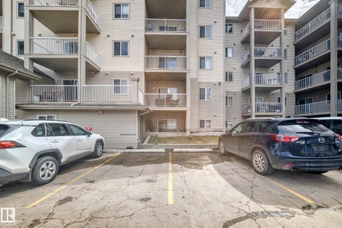 Assigned parking spaces in a multi-story residential building with private balconies - 317 7511 171 Street, Edmonton, AB - Outdoor With Balcony